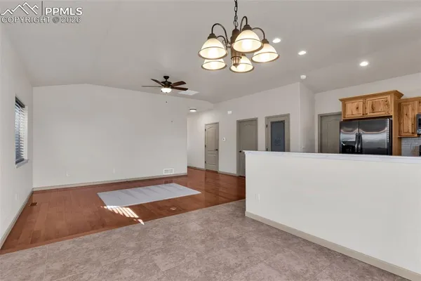 a view of an empty room with a chandelier