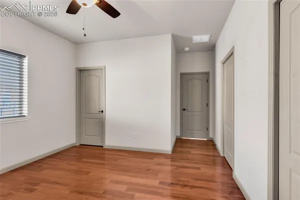 a view of an empty room with wooden floor