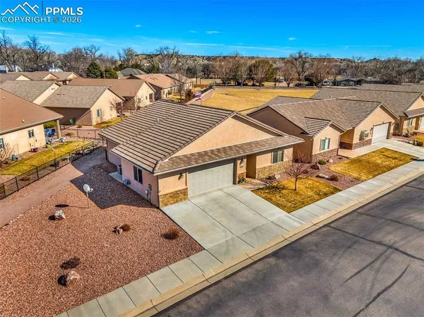 an aerial view of residential houses with outdoor space