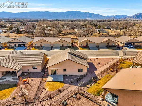 an aerial view of residential houses with outdoor space