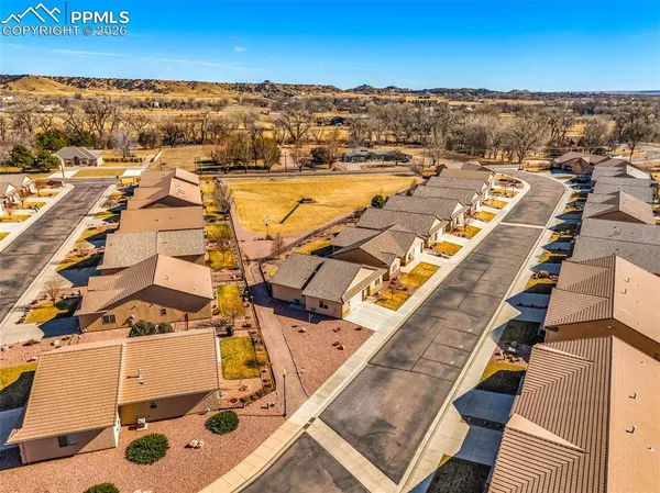 an aerial view of residential houses with outdoor space