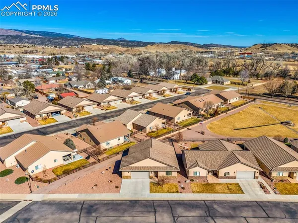 an aerial view of residential houses with outdoor space