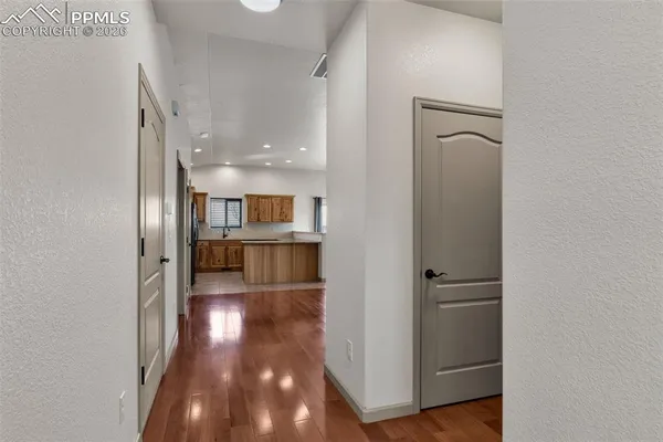 a view of a hallway with wooden floor