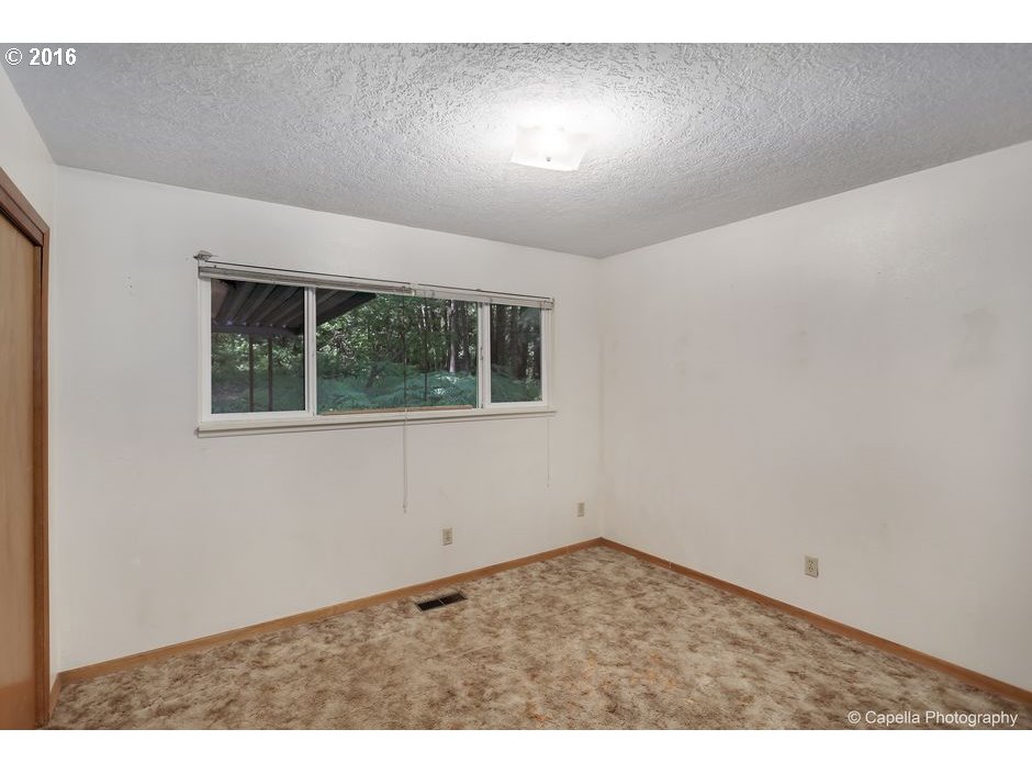 19428 Northwest Logie Trail Road Portland, OR 97231 - Photo 12 of 20 an empty room with a window