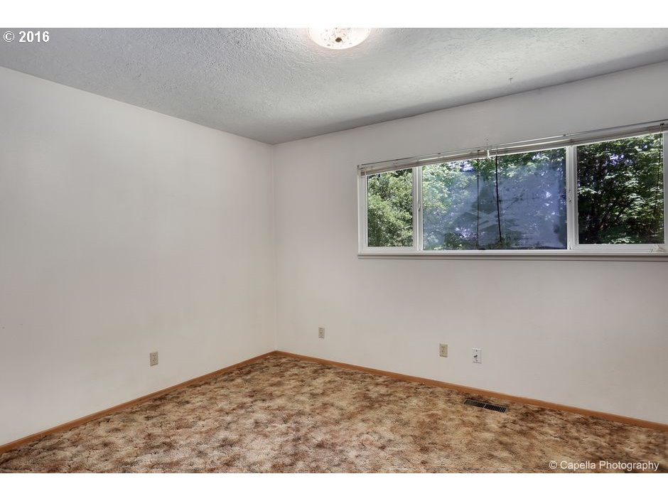 19428 Northwest Logie Trail Road Portland, OR 97231 - Photo 14 of 20 an empty room with a window