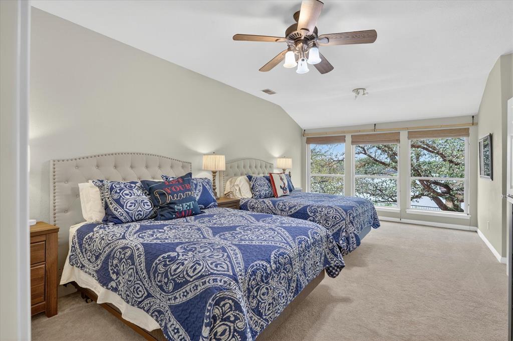 8877 Random Road Fort Worth, TX 76179 - Photo 25 of 40 a large bedroom with a large bed and a chandelier fan