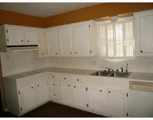 a kitchen with white cabinets