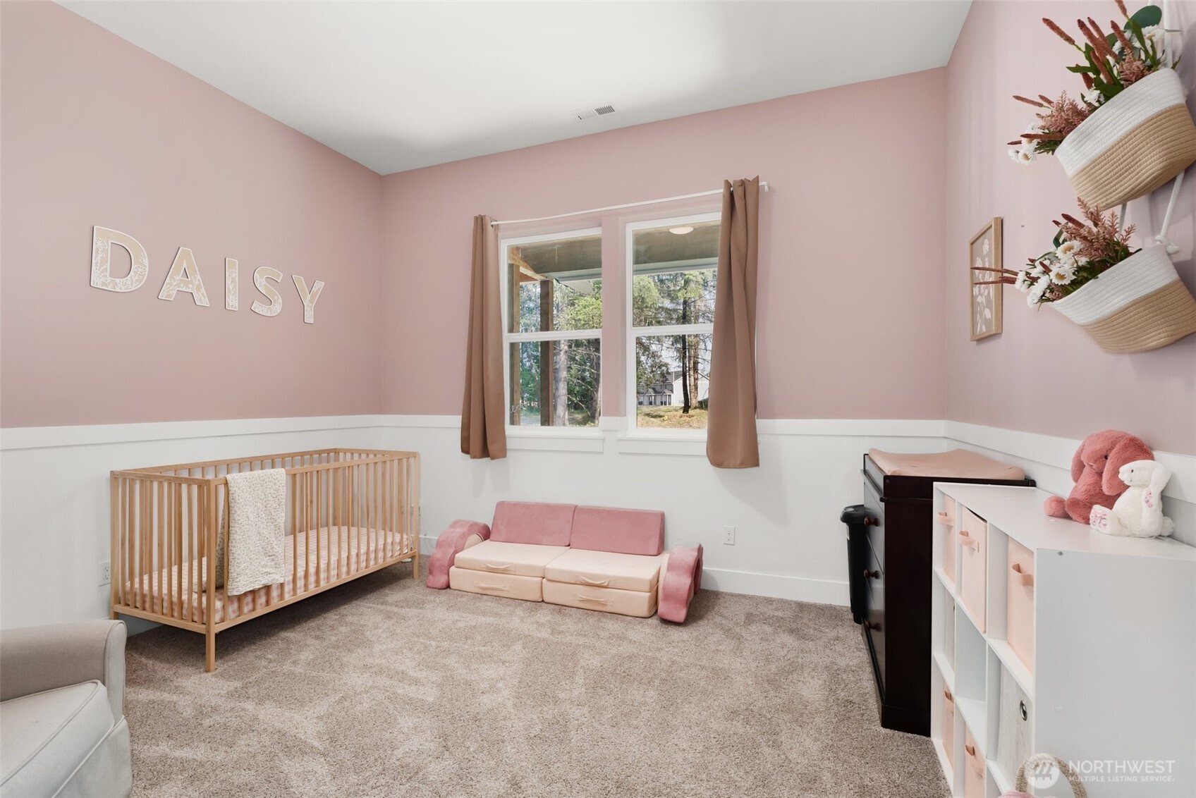 809 Southwest Gertrude Avenue Winlock, WA 98596 - Photo 19 of 40 a bedroom with a baby bed baby crib and a couch