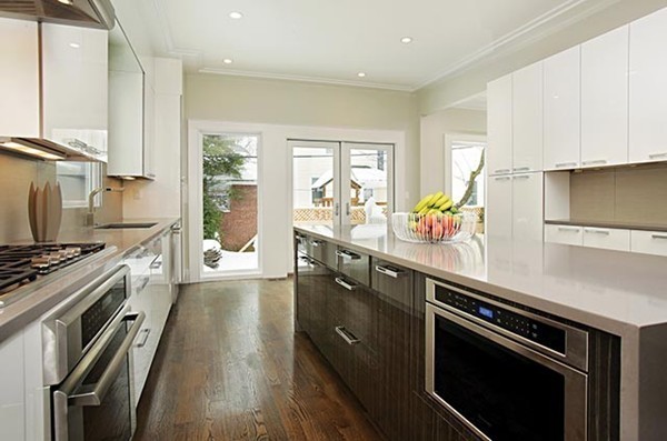 69 Coolidge Street Brookline, MA 02446 - Photo 5 of 9 a kitchen with stainless steel appliances a sink stove and cabinets