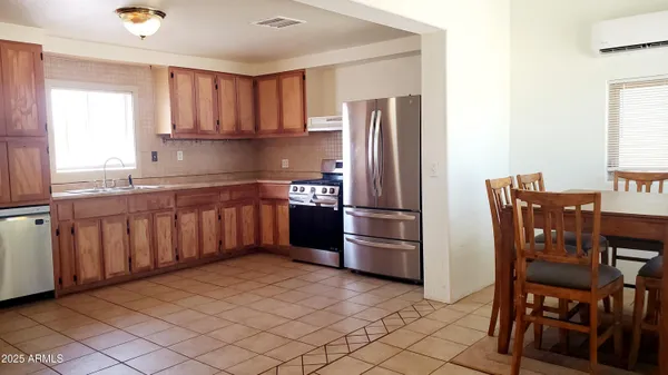 a kitchen with stainless steel appliances granite countertop a refrigerator and a stove top oven