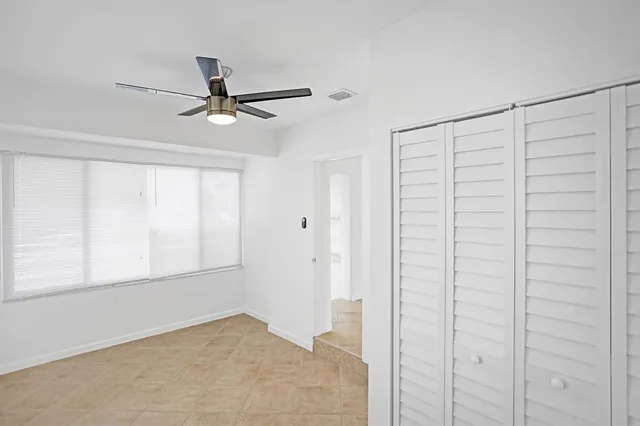 a view of empty room with ceiling fan