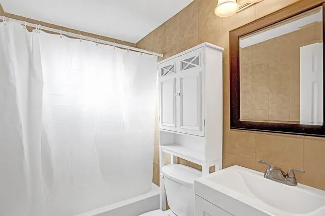 a bathroom with a shower curtain and a sink
