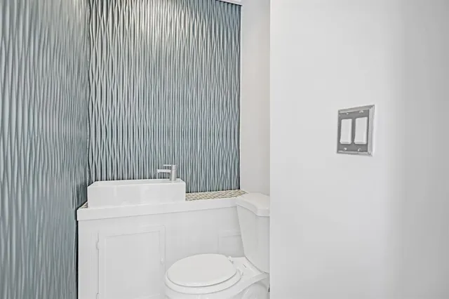 a bathroom with a toilet and a sink