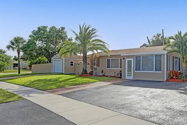 a front view of a house with a yard and a garage