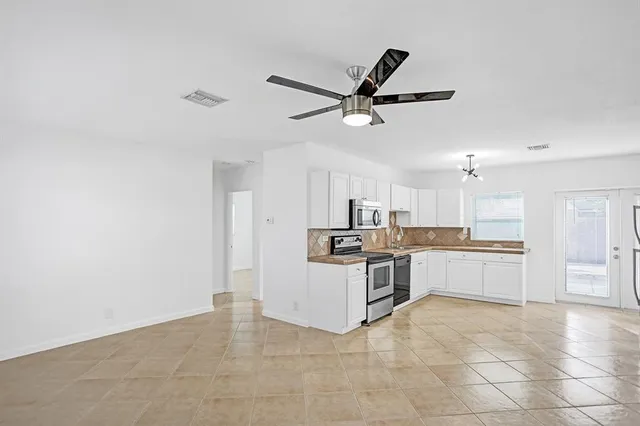 a kitchen with a sink cabinets and stainless steel appliances