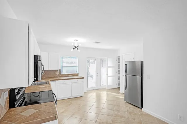 a kitchen with a refrigerator and a sink