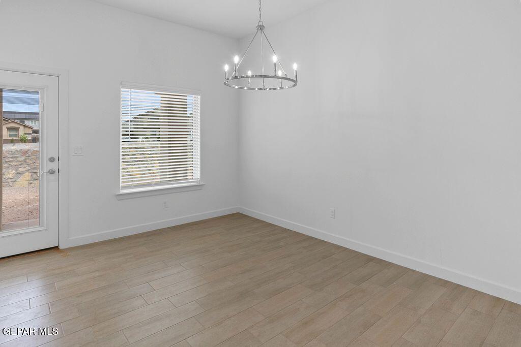 3757 Course Street El Paso, TX 79938 - Photo 11 of 14 wooden floor in an empty room with a window