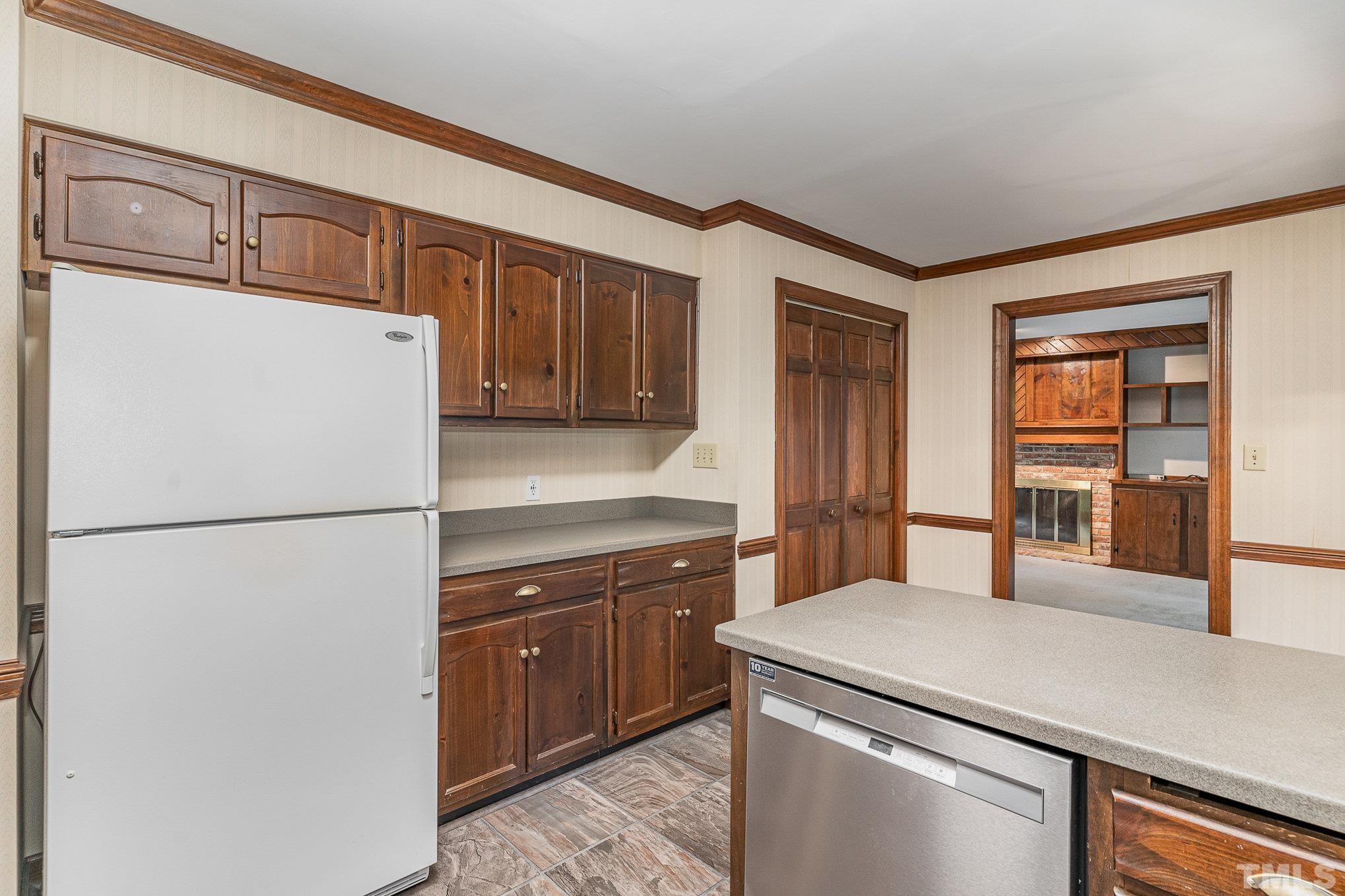 4909 Springwood Drive Raleigh, NC 27613 - Photo 14 of 59 a kitchen with a refrigerator sink and cabinets