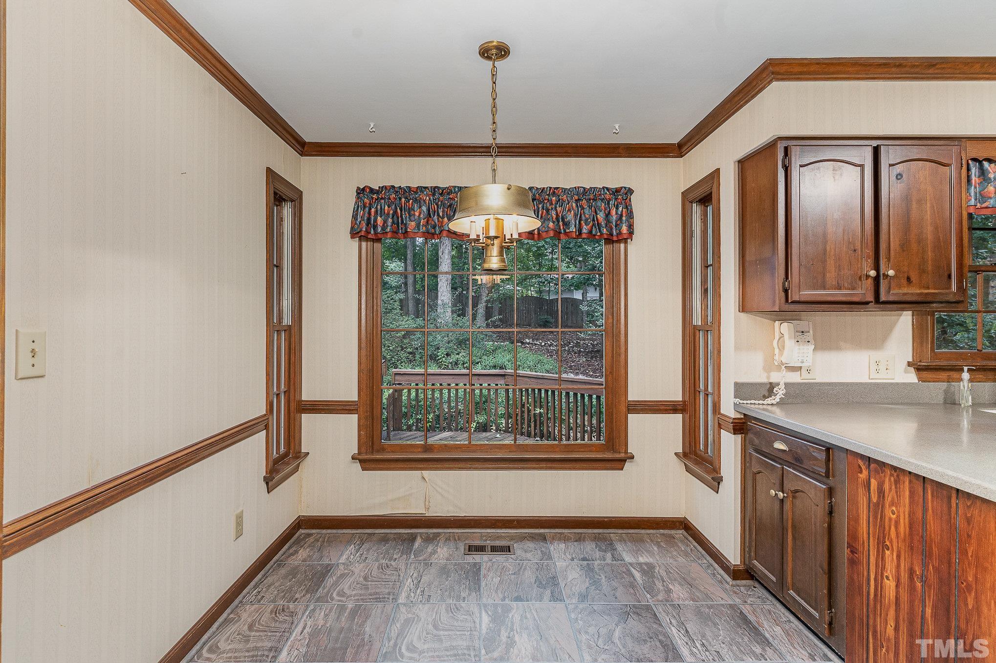 4909 Springwood Drive Raleigh, NC 27613 - Photo 17 of 59 a view of a kitchen with a sink wooden floor and cabinets