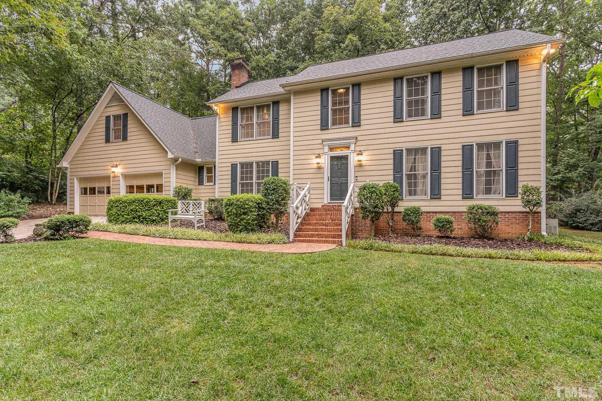 4909 Springwood Drive Raleigh, NC 27613 - Photo 2 of 59 a front view of a house with a yard and plants
