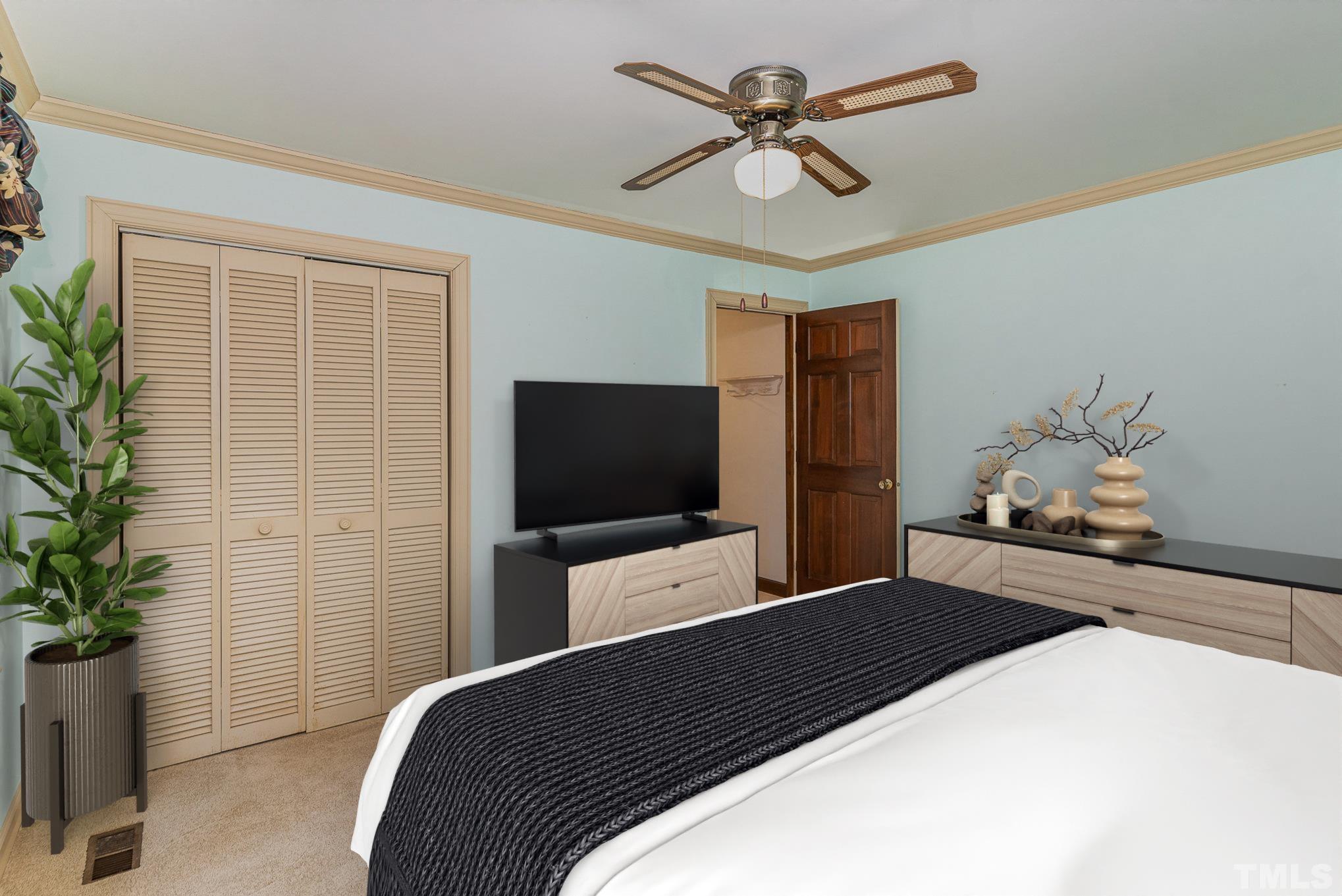 4909 Springwood Drive Raleigh, NC 27613 - Photo 24 of 59 a bedroom with a bed and a flat screen tv