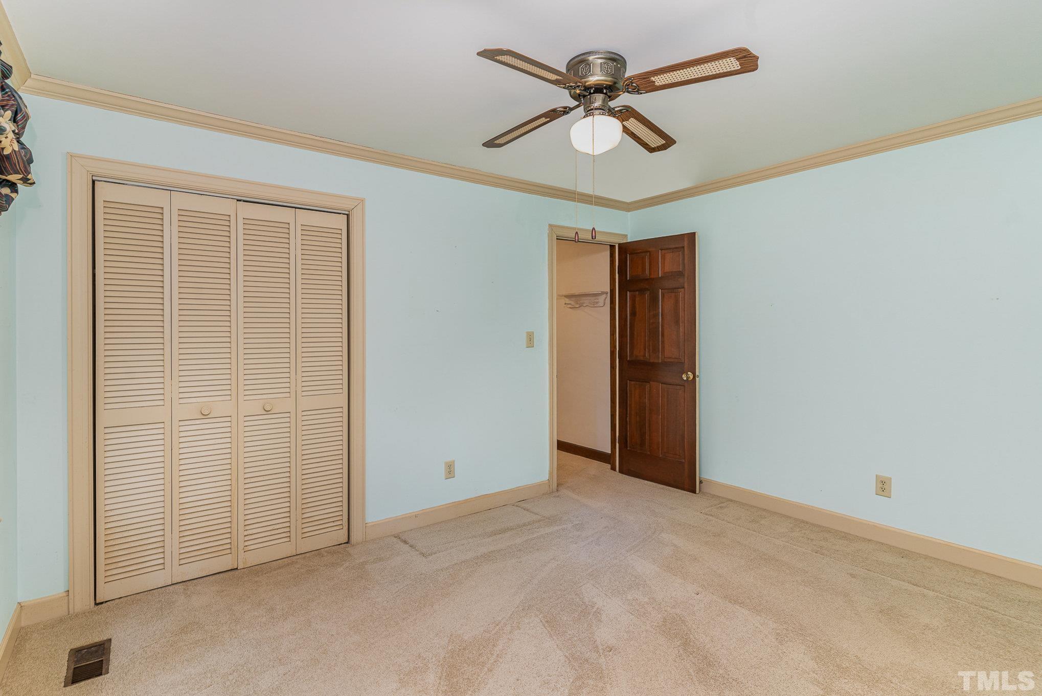 4909 Springwood Drive Raleigh, NC 27613 - Photo 25 of 59 an empty room with closet and a ceiling fan