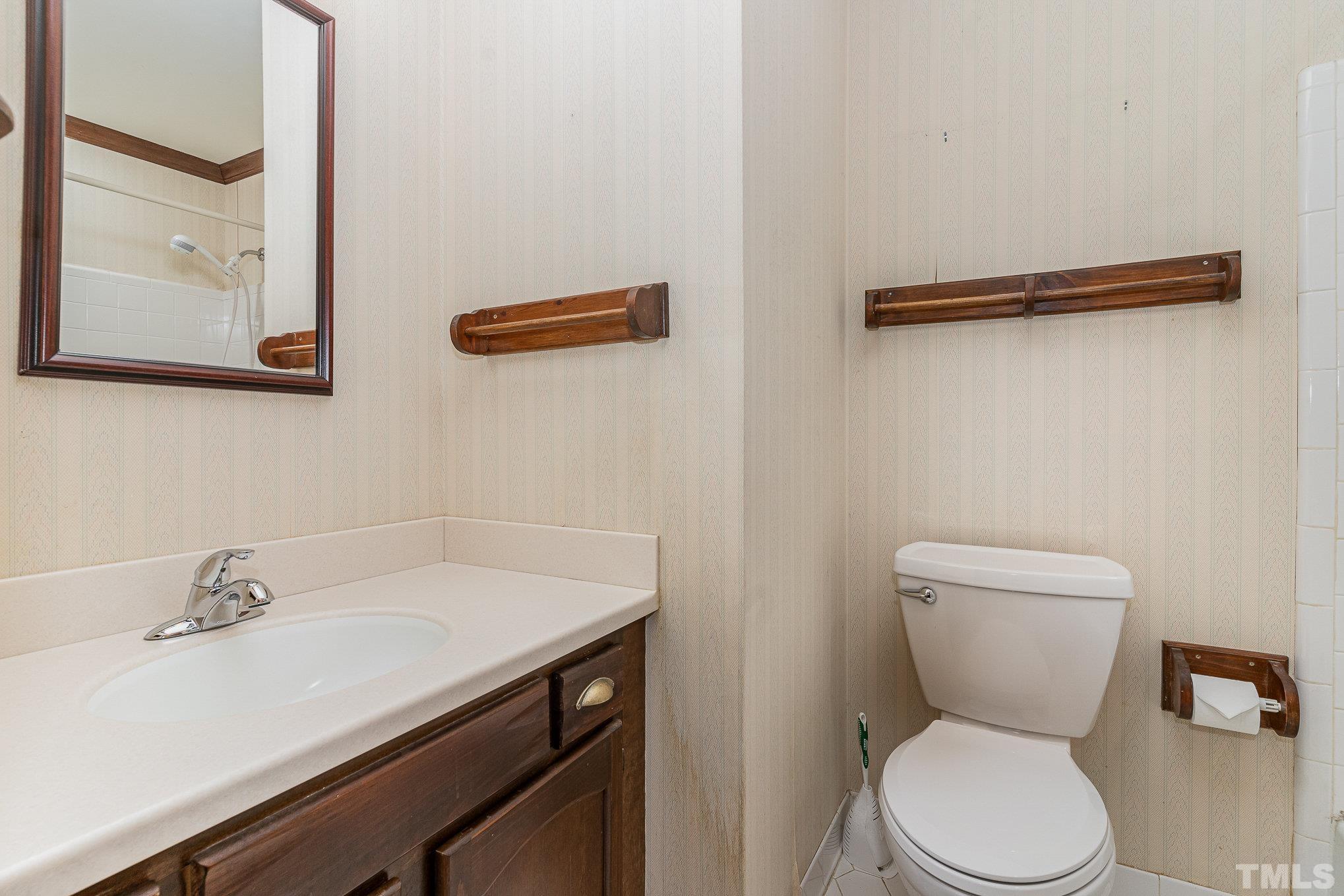 4909 Springwood Drive Raleigh, NC 27613 - Photo 28 of 59 a bathroom with a toilet sink and mirror