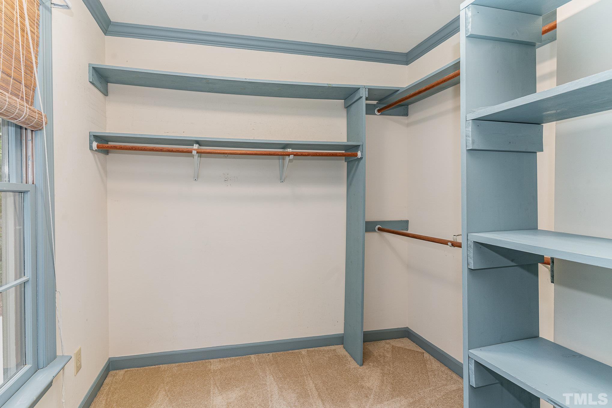 4909 Springwood Drive Raleigh, NC 27613 - Photo 33 of 59 a view of walk in closet with empty racks