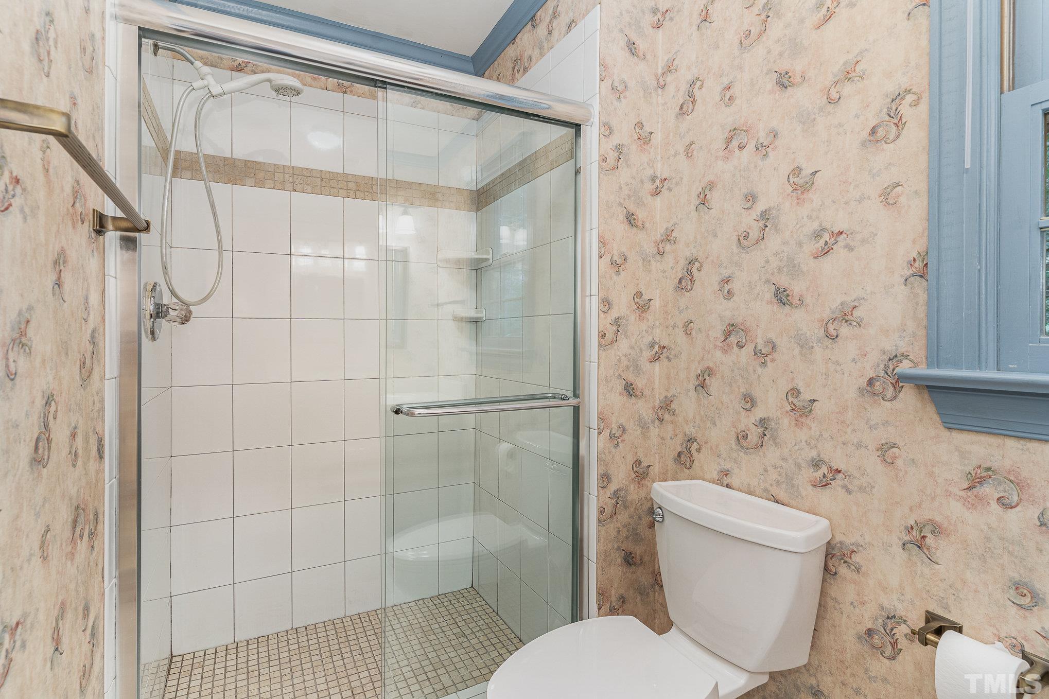 4909 Springwood Drive Raleigh, NC 27613 - Photo 35 of 59 a white toilet sitting next to a shower curtain