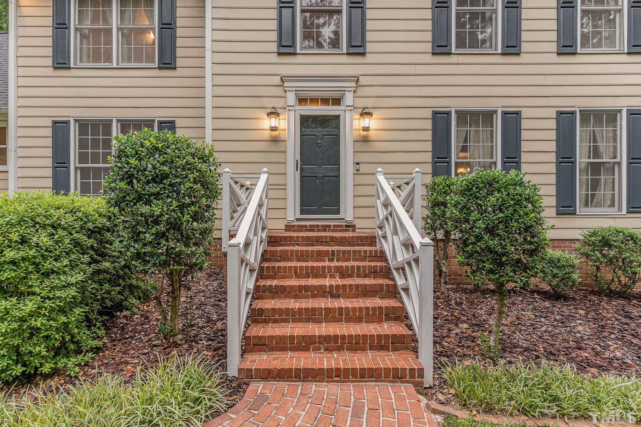 4909 Springwood Drive Raleigh, NC 27613 - Photo 4 of 59 a view of a house with more windows and brick walls
