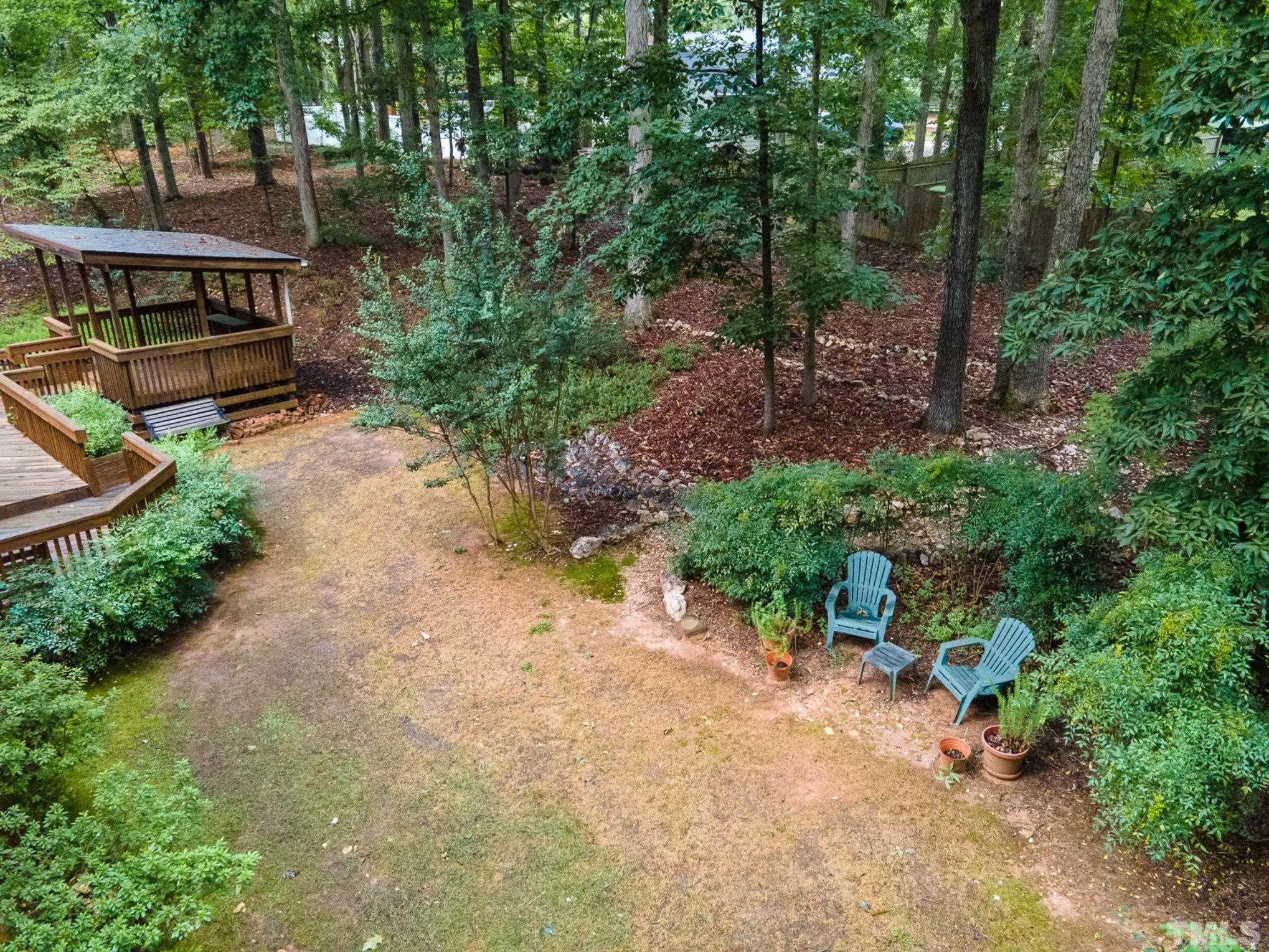 4909 Springwood Drive Raleigh, NC 27613 - Photo 52 of 59 a view of a house with a yard and sitting area