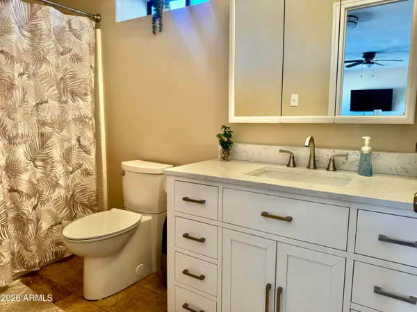 a bathroom with a sink toilet and shower