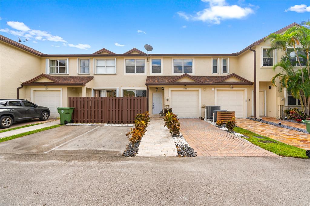 9580 Southwest 2nd Ct., Unit 9580 Pembroke Pines, FL 33025 - Photo 1 of 33 a front view of a house with a yard and garage
