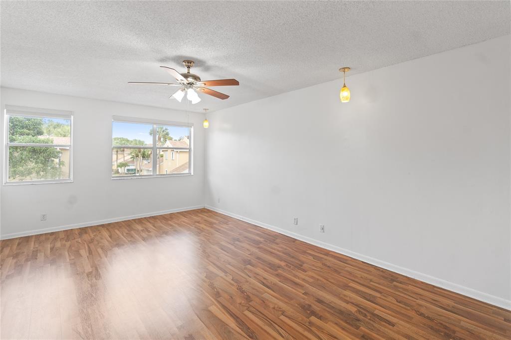 9580 Southwest 2nd Ct., Unit 9580 Pembroke Pines, FL 33025 - Photo 21 of 33 wooden floor in an empty room with a window