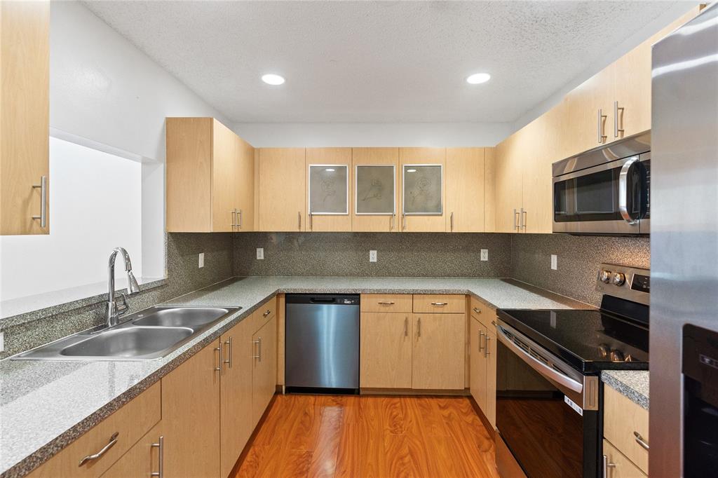 9580 Southwest 2nd Ct., Unit 9580 Pembroke Pines, FL 33025 - Photo 9 of 33 a kitchen with a sink stove and microwave