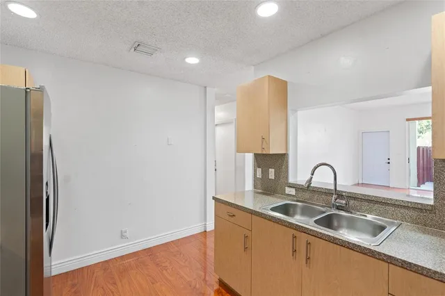 a kitchen with a sink and a refrigerator