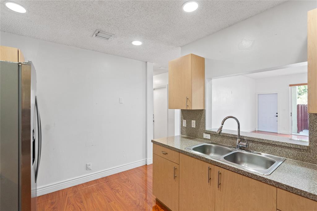 9580 Southwest 2nd Ct., Unit 9580 Pembroke Pines, FL 33025 - Photo 10 of 33 a kitchen with a sink and a refrigerator