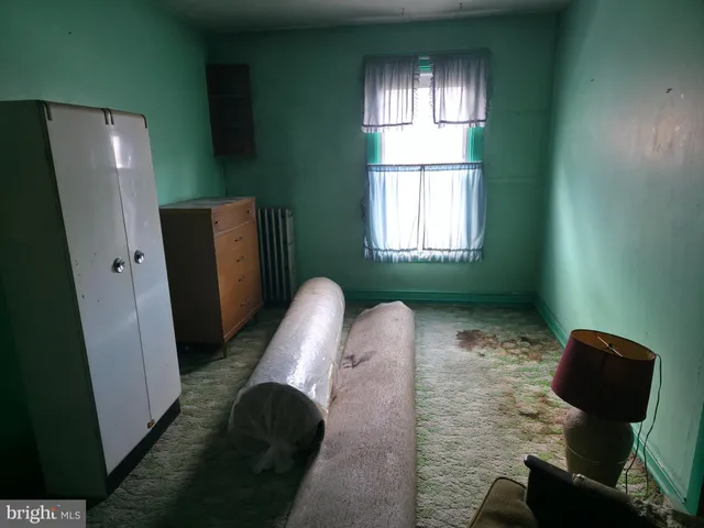 a view of a livingroom with furniture and a window