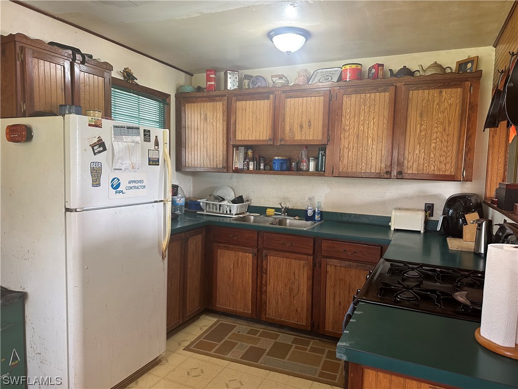 22841 North River Road Alva, FL 33920 - Photo 16 of 23 a kitchen with stainless steel appliances granite countertop a refrigerator and a sink