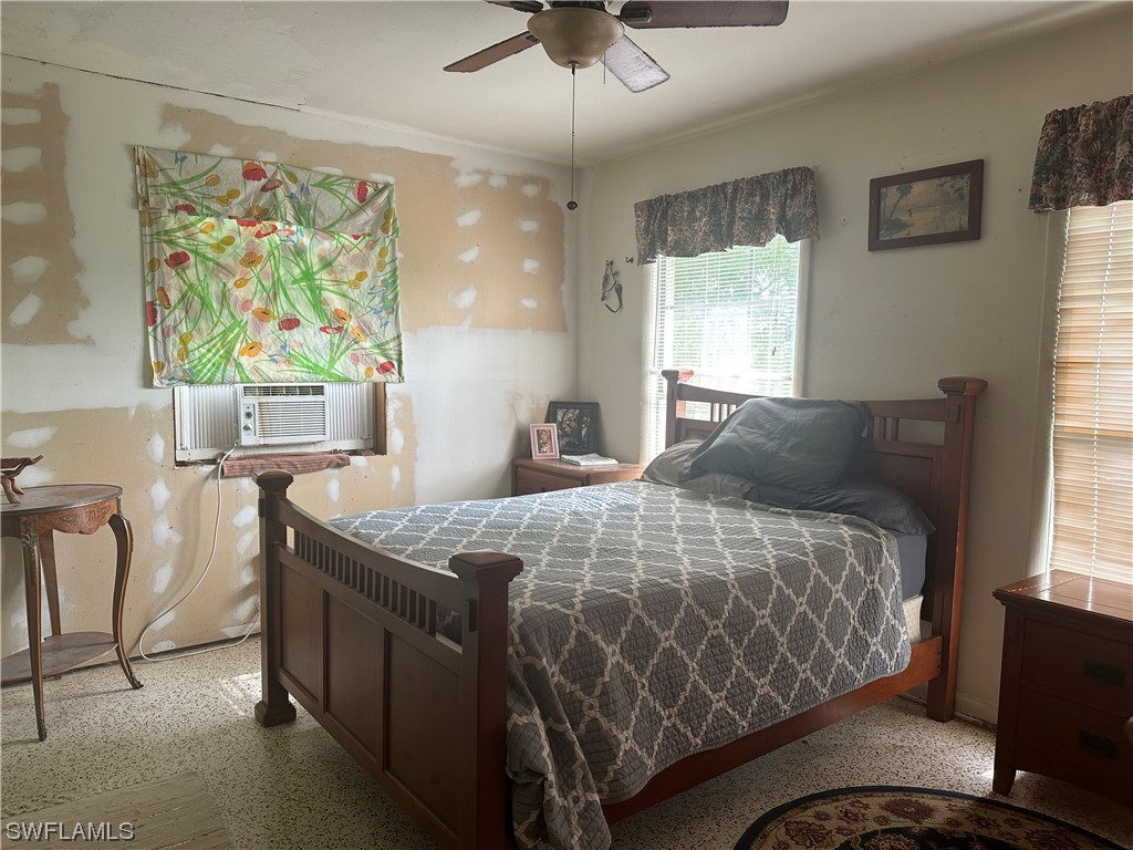 22841 North River Road Alva, FL 33920 - Photo 22 of 23 a bedroom with a bed and a chandelier