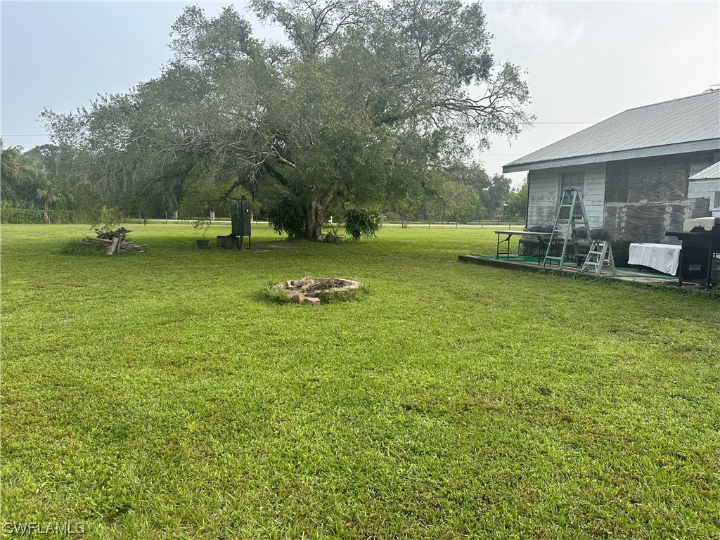 22841 North River Road Alva, FL 33920 - Photo 7 of 23 a view of a house with swimming pool and yard