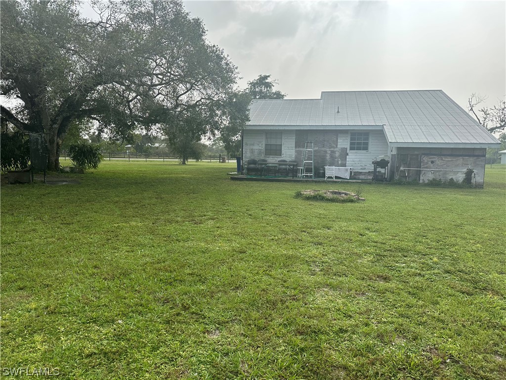22841 North River Road Alva, FL 33920 - Photo 8 of 23 a front view of house with yard and trees