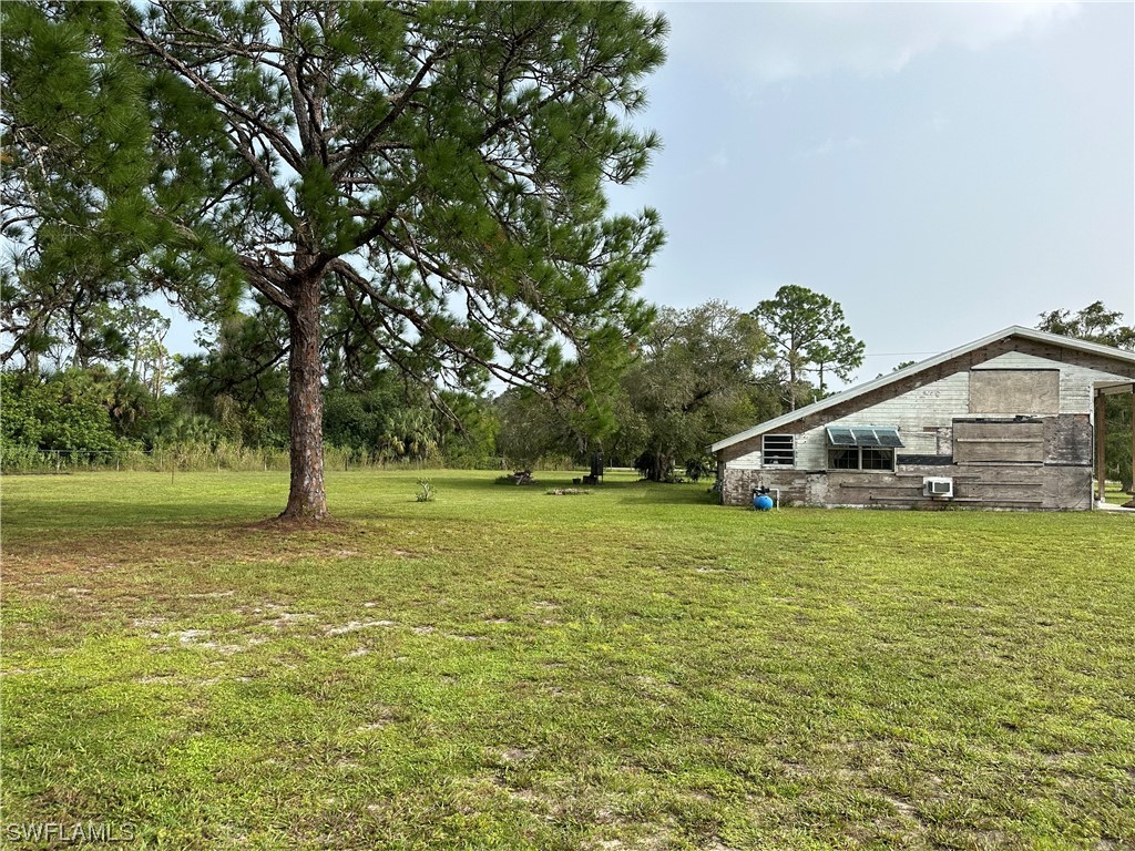 22841 North River Road Alva, FL 33920 - Photo 10 of 23 a house with garden in front of it