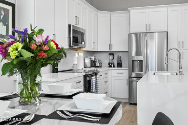 a kitchen with sink refrigerator and stove