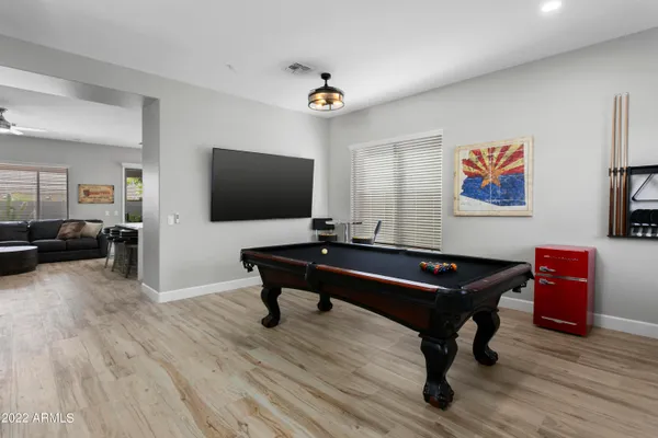 a room with furniture pool table and flat screen tv