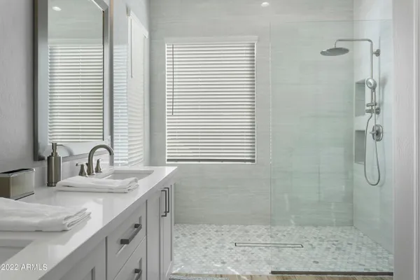 a bathroom with a granite countertop sink a shower and a mirror