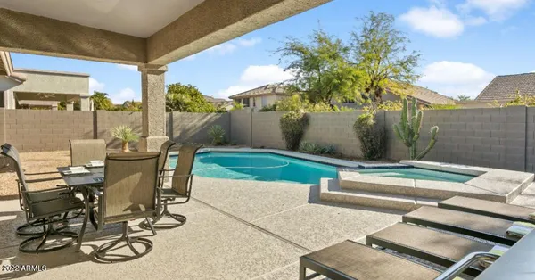 a view of a patio with table and chairs and potted plants