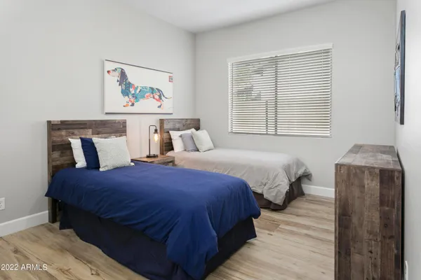 a bedroom with bed and wooden floor