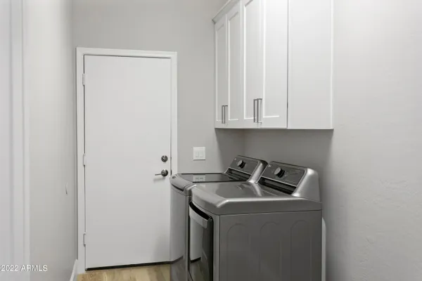 a utility room with sink dryer and washer