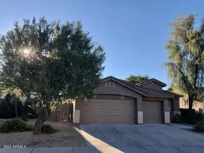 a view of a house with a yard and tree s